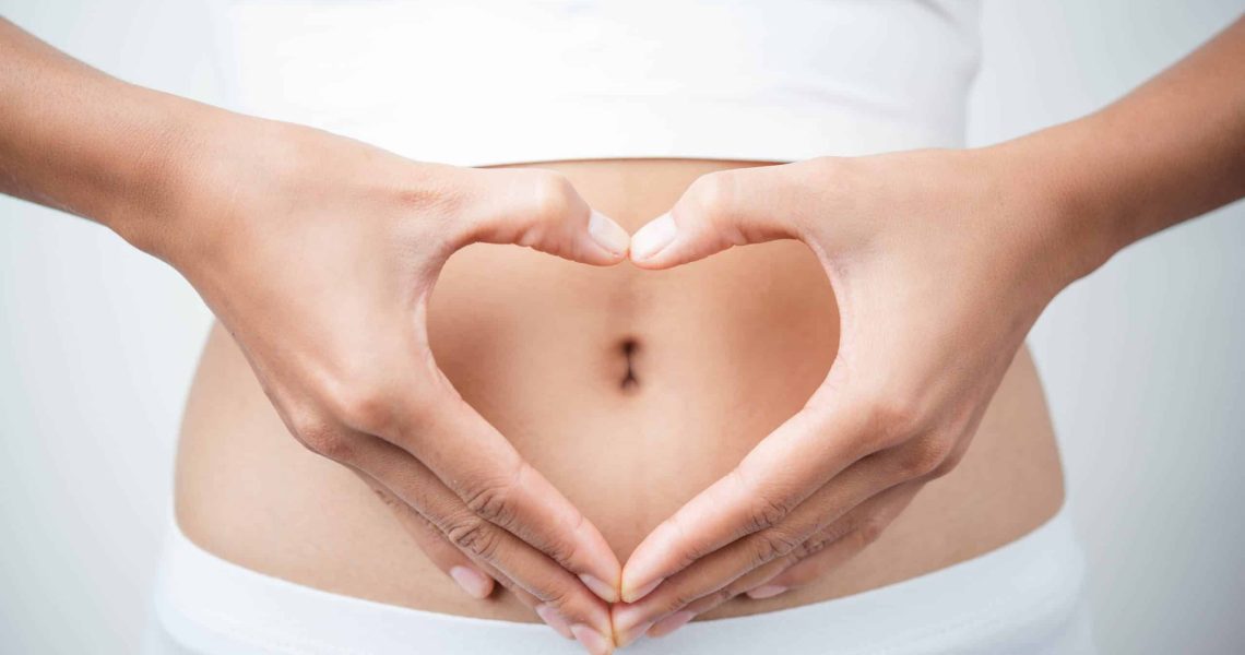 Close,Up,Of,Woman's,Hands,Made,Heart,On,Belly,Isolated